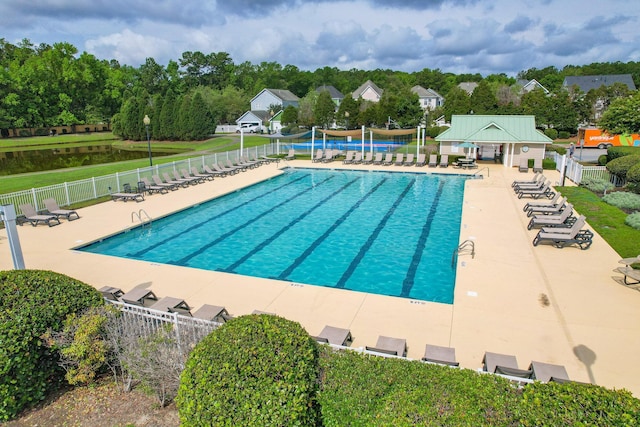 community pool with fence and a patio area