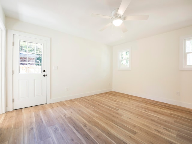 foyer entrance with light wood-type flooring, ceiling fan, and plenty of natural light