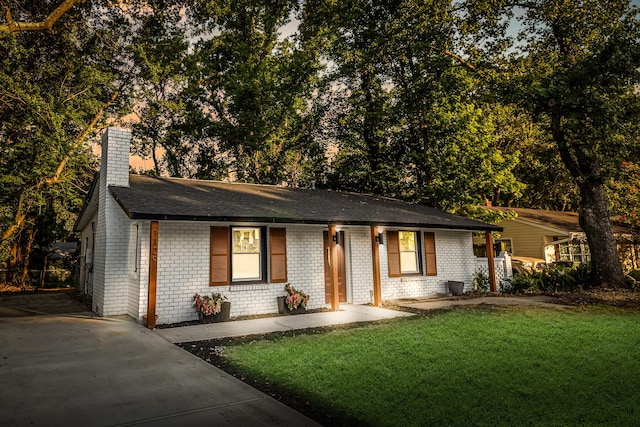1129 Dickson Ave, Hanahan, SC 29410 - ranch-style home with brick siding, a chimney, a front lawn, roof with shingles, and concrete driveway