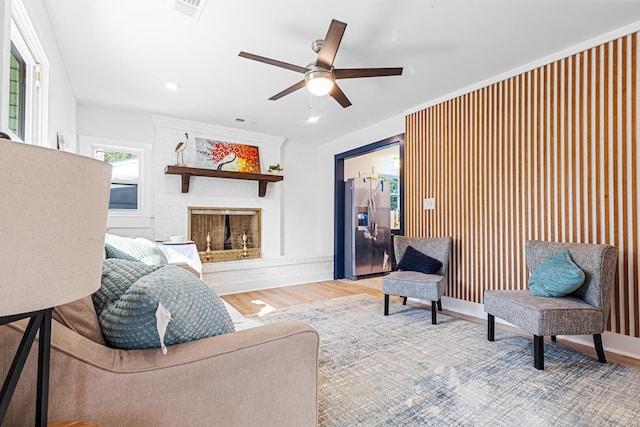 1129 Dickson Ave, Hanahan, SC 29410 - living area featuring a large fireplace, ceiling fan, and wood finished floors