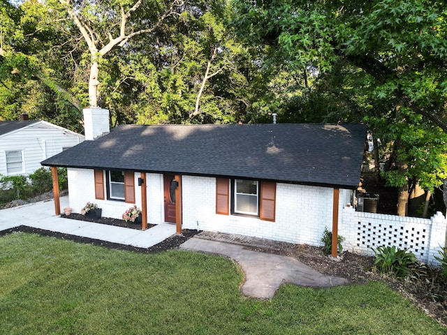 1129 Dickson Ave, Hanahan, SC 29410 - single story home featuring brick siding, roof with shingles, a chimney, and a front lawn