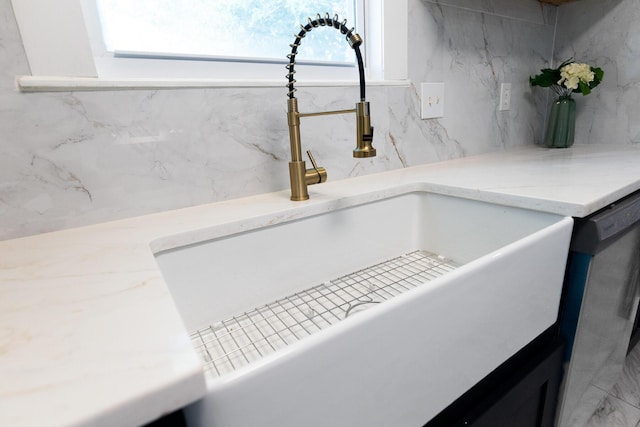 1129 Dickson Ave, Hanahan, SC 29410 - kitchen view of decorative backsplash, stainless steel dishwasher, and light stone countertops