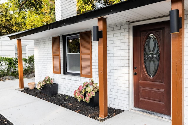 1129 Dickson Ave, Hanahan, SC 29410 - doorway to property with covered porch, brick siding, and a chimney