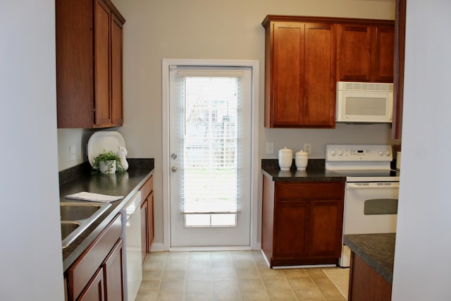 kitchen featuring white appliances, a healthy amount of sunlight, and sink