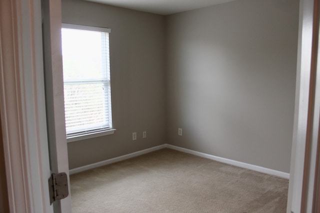 unfurnished room with light colored carpet