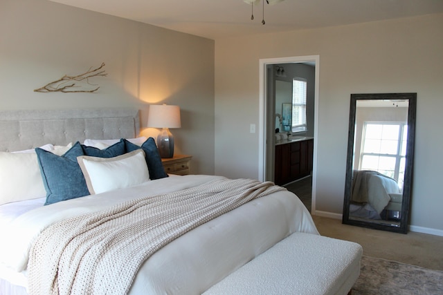 carpeted bedroom featuring connected bathroom