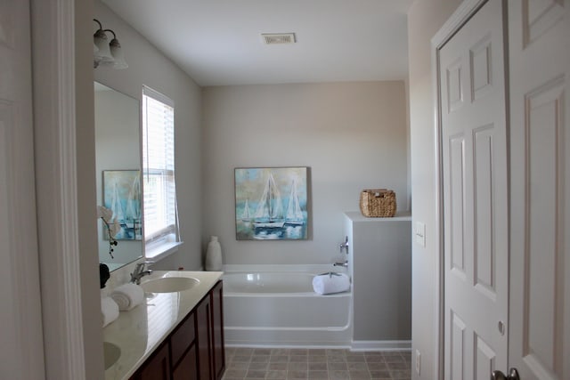 bathroom featuring a tub and vanity