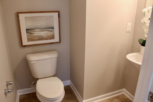 bathroom with tile patterned flooring and toilet