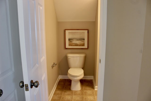 bathroom featuring lofted ceiling and toilet