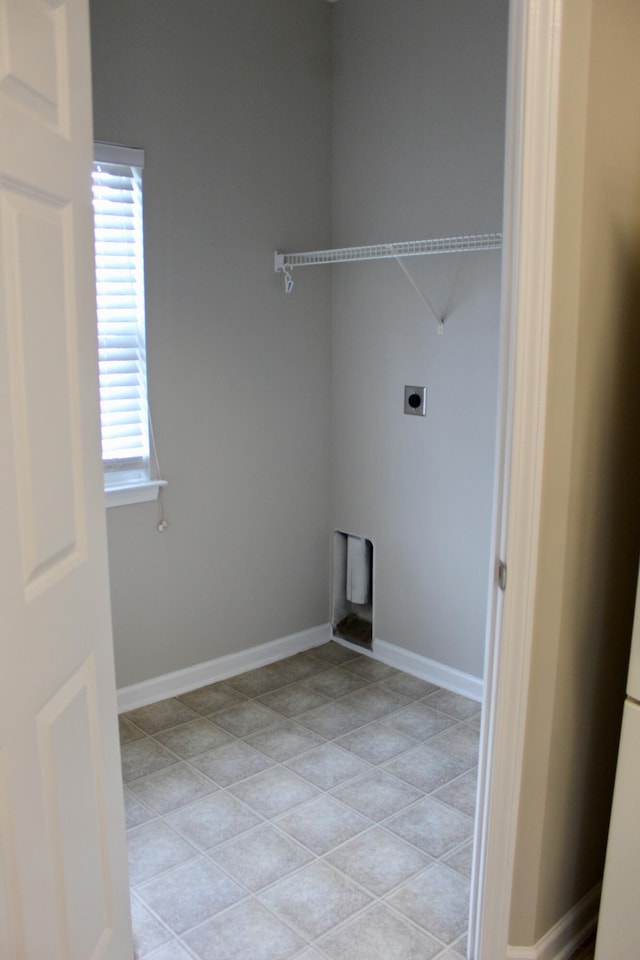 laundry room with hookup for an electric dryer and plenty of natural light