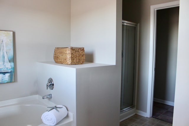 bathroom featuring separate shower and tub