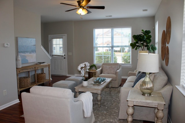 living room featuring plenty of natural light, ceiling fan, and dark hardwood / wood-style flooring