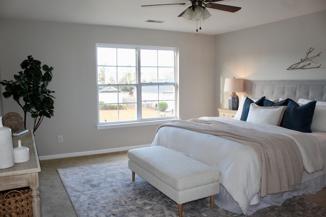 carpeted bedroom with multiple windows and ceiling fan