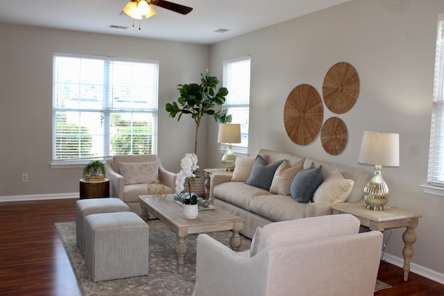 living room featuring a wealth of natural light, ceiling fan, and dark hardwood / wood-style floors