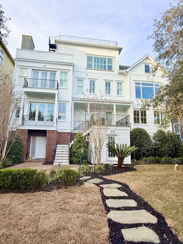 back of house featuring stairway