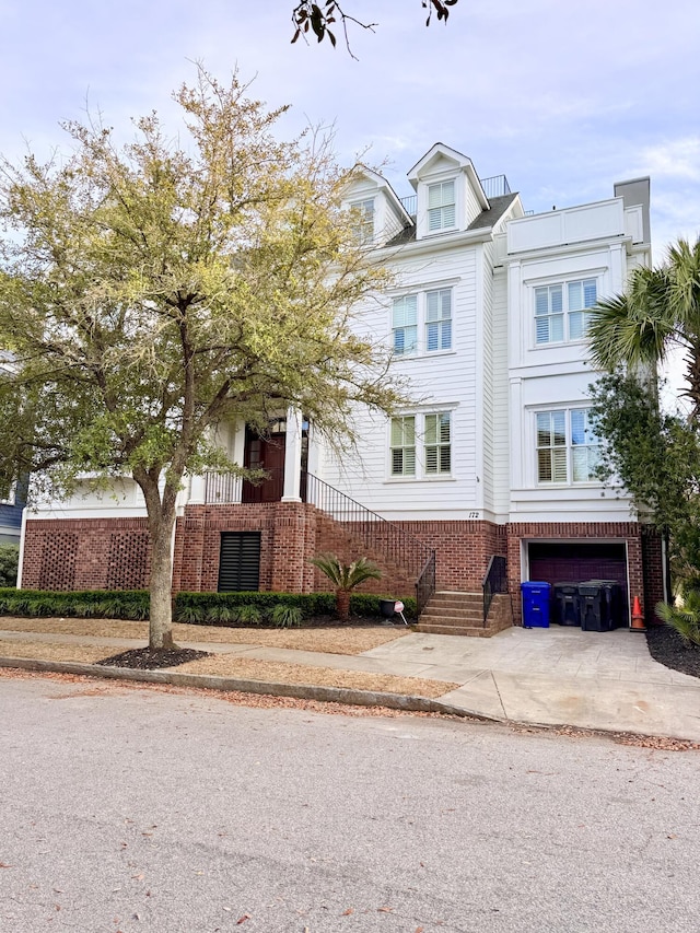 view of front of property with driveway, brick siding, and an attached garage