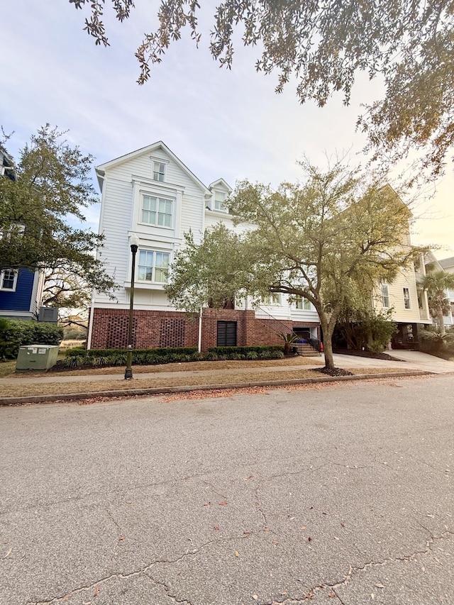 view of front of house with a fenced front yard and brick siding