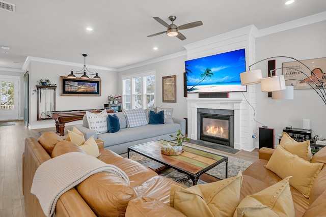 living room featuring ceiling fan, ornamental molding, billiards, and light hardwood / wood-style flooring