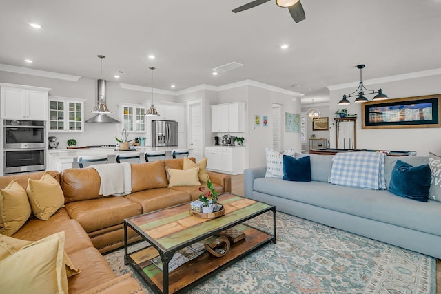 living room featuring ceiling fan and crown molding