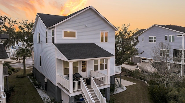 back house at dusk with a yard