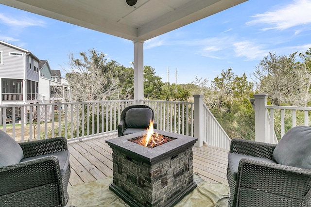 wooden deck featuring a fire pit