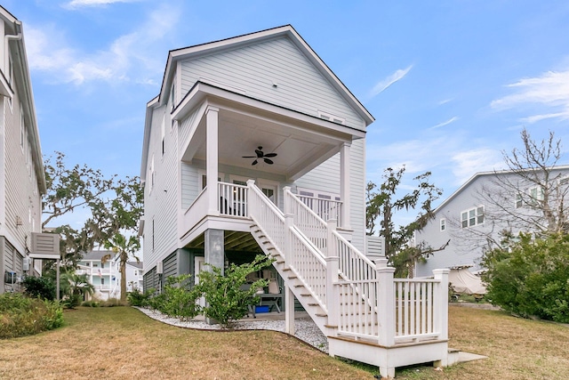 rear view of house featuring a lawn, ceiling fan, and covered porch