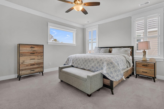 carpeted bedroom with ceiling fan and crown molding