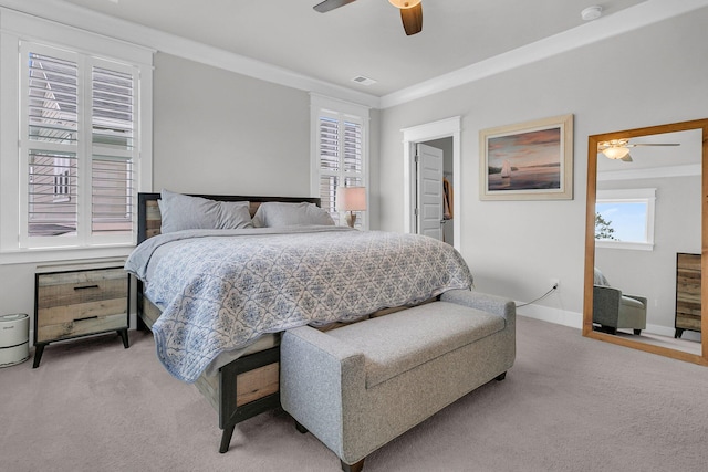 carpeted bedroom with ceiling fan and crown molding