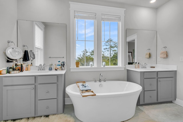 bathroom featuring a washtub and vanity