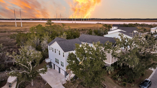 aerial view at dusk with a water view