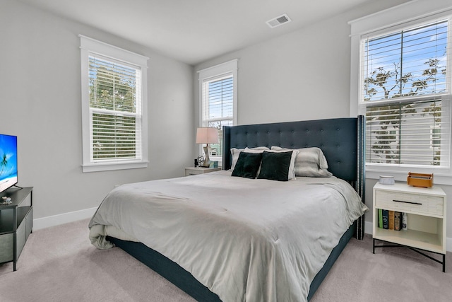 bedroom featuring light colored carpet