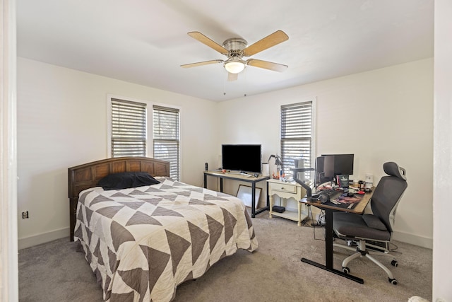 bedroom featuring baseboards, multiple windows, and light carpet