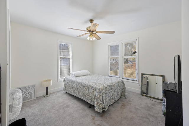 carpeted bedroom featuring baseboards and ceiling fan