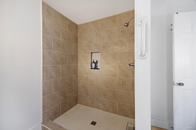 bathroom with tiled shower