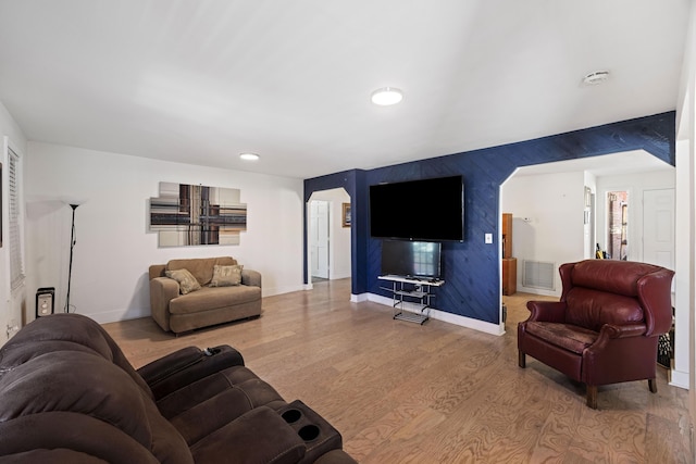 living area with visible vents, an accent wall, baseboards, recessed lighting, and wood finished floors