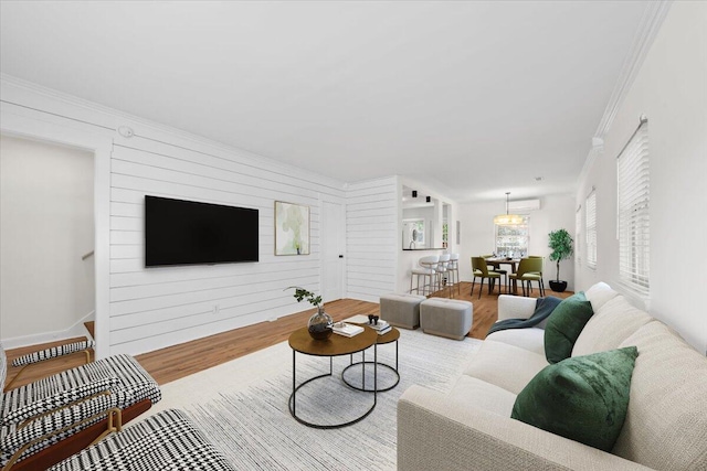 living room featuring light wood-type flooring and ornamental molding