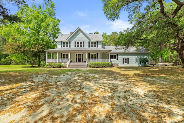 5950 Kelseys Mill Rd, Ravenel, SC 29470 - view of front of home with a chimney, a porch, a front lawn, and roof with shingles