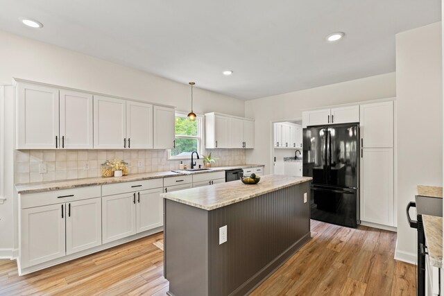 5950 Kelseys Mill Rd, Ravenel, SC 29470 - kitchen featuring tasteful backsplash, white cabinetry, freestanding refrigerator, light wood-style floors, and a sink