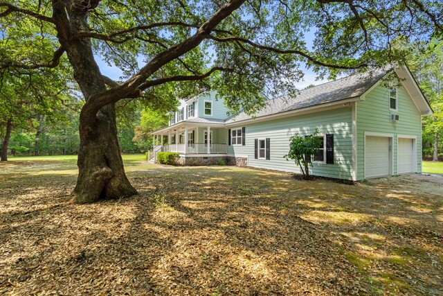 5950 Kelseys Mill Rd, Ravenel, SC 29470 - rear view of property with a porch, a shingled roof, and a garage