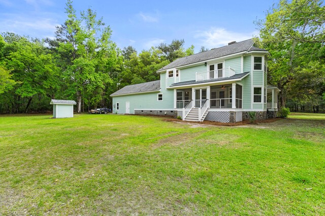 5950 Kelseys Mill Rd, Ravenel, SC 29470 - rear view of property featuring a sunroom, a yard, an outdoor structure, a storage unit, and a shingled roof