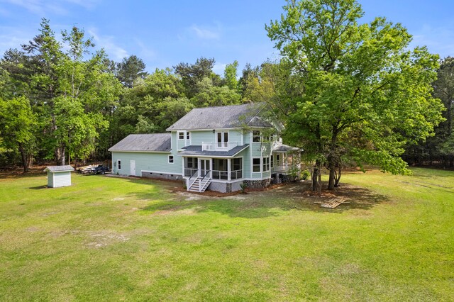 5950 Kelseys Mill Rd, Ravenel, SC 29470 - rear view of house featuring a shed, a sunroom, crawl space, an outdoor structure, and a lawn
