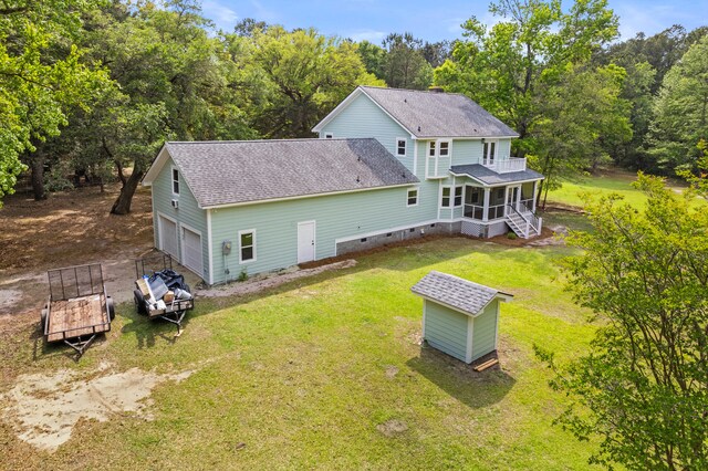 5950 Kelseys Mill Rd, Ravenel, SC 29470 - back of house featuring roof with shingles, crawl space, a garage, a sunroom, and a lawn