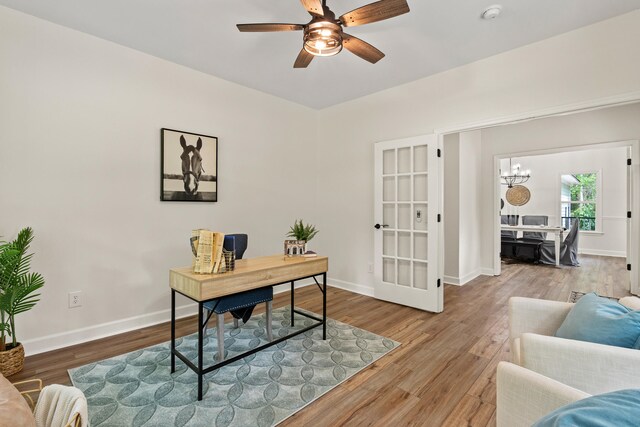 5950 Kelseys Mill Rd, Ravenel, SC 29470 - office area with french doors, ceiling fan with notable chandelier, baseboards, and wood finished floors