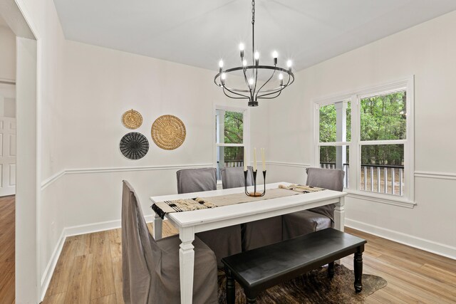 5950 Kelseys Mill Rd, Ravenel, SC 29470 - dining room featuring a chandelier, light wood-style floors, and baseboards