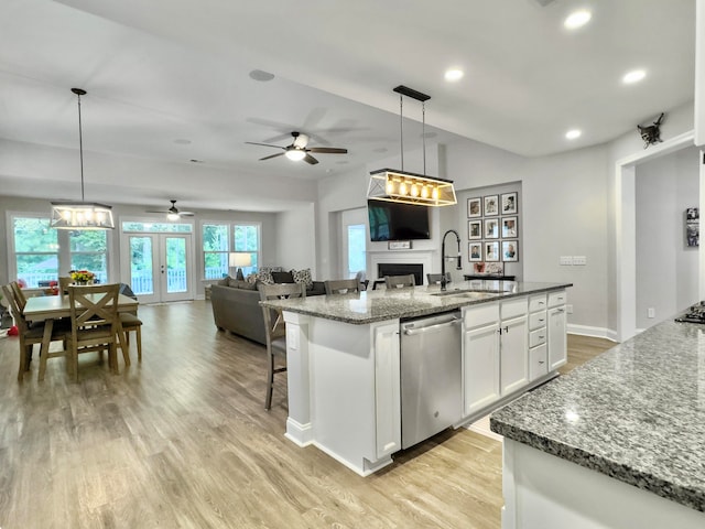 kitchen with ceiling fan, white cabinets, sink, decorative light fixtures, and dishwasher