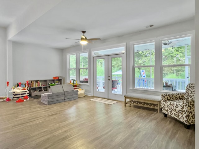 living room with ceiling fan, hardwood / wood-style flooring, and french doors