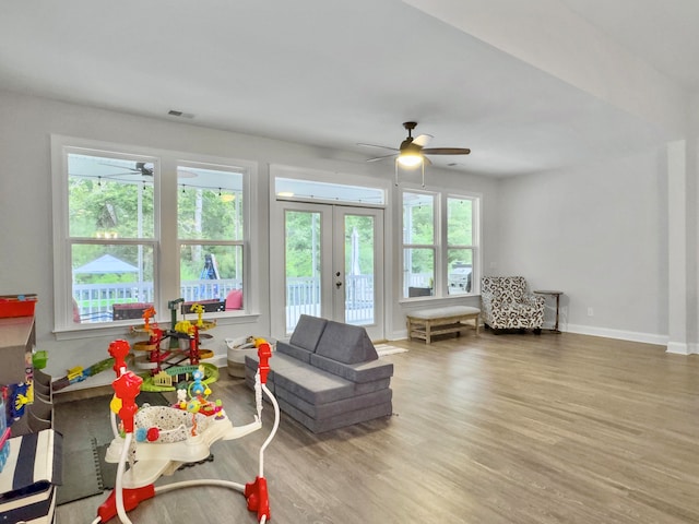 living room with french doors, plenty of natural light, hardwood / wood-style floors, and ceiling fan