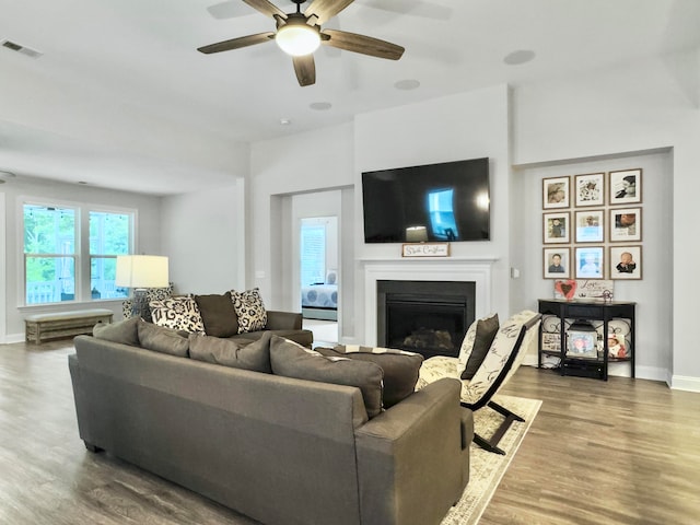 living room featuring ceiling fan and hardwood / wood-style flooring