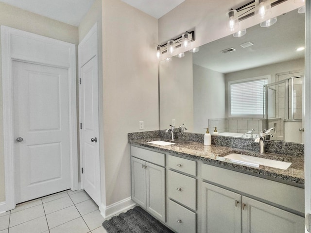 bathroom featuring vanity, tile patterned floors, and a shower with shower door