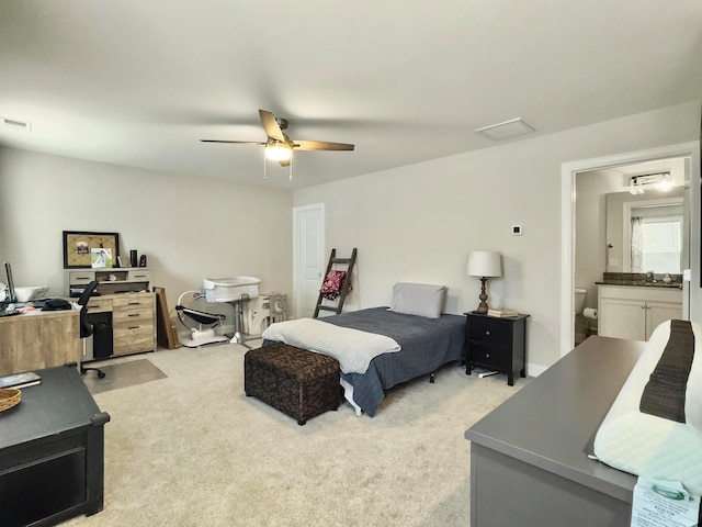 carpeted bedroom featuring ensuite bath and ceiling fan